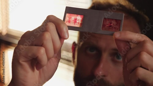 Close-up of a man looking at photo slides