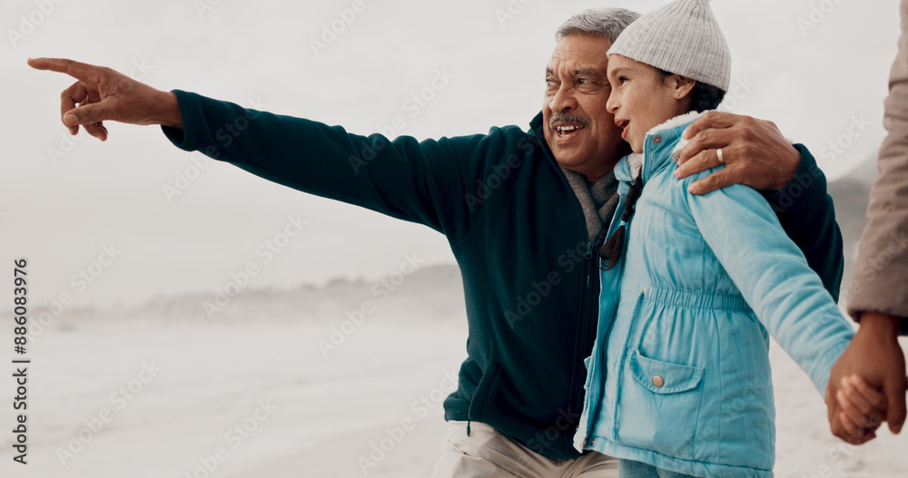 Φωτογραφία Grandpa, child and beach with pointing, happy and family together on vacation by the sea with view