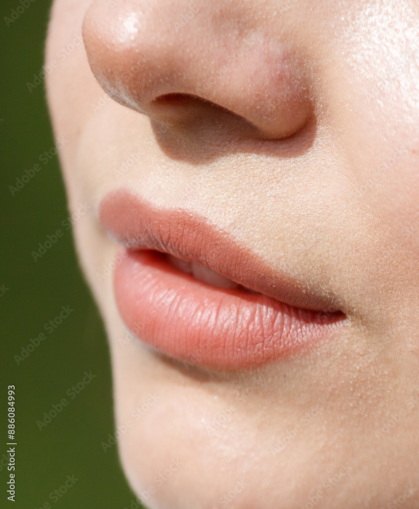 Fototapeta premium Close-up of lips on a girl's face. Macro