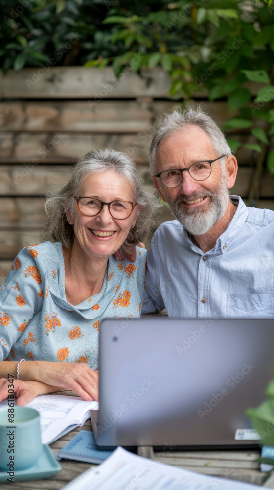 A couple of 60-year-olds sitting in front of a laptop. AI generative. A couple of 60-year-olds sitting in front of a laptop. AI generative.