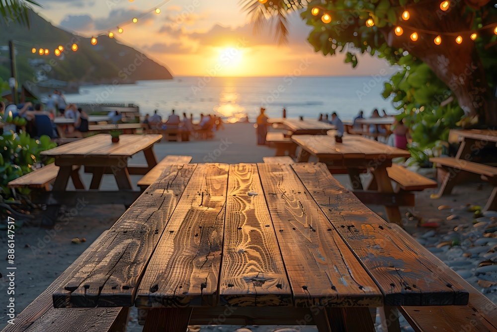 Fototapeta premium Sunset Beachside Dining: Scenic Oceanfront View with Picnic Tables and String Lights for Summer Relaxation