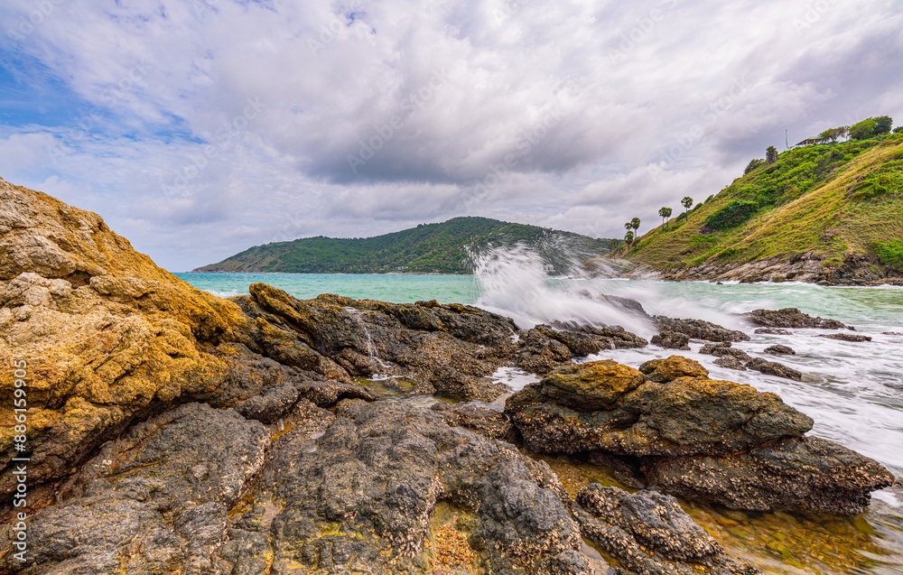 Fototapeta premium Huge waves crashed against the rocks until the water splashed..Small island in the green sea near Yanui Beach There are rocks and coral reefs for snorkeling and a sandbar between the two beaches..