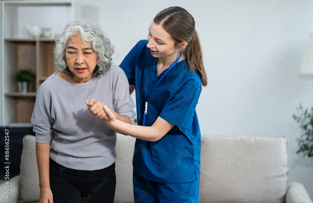 Fototapeta premium young caregiver assists her elderly woman patient at a nursing home. senior woman is assisted by a nurse at home.