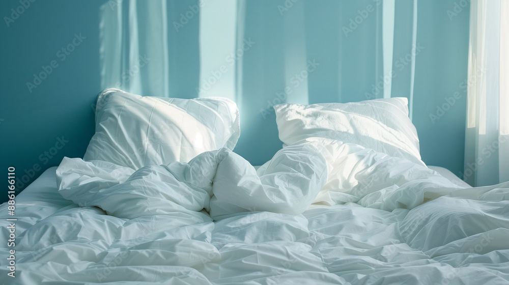 white pillows and duvet on a bed with blue wall white pillows and duvet on a bed with blue wall