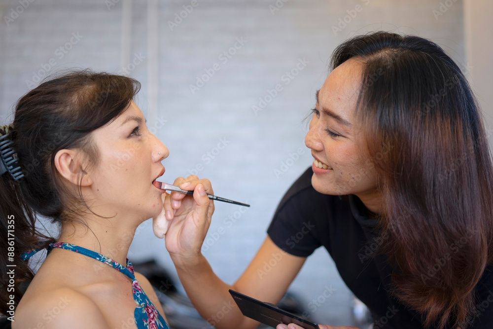 Young woman is make up her face at beauty salon. Young woman is make up her face at beauty salon.