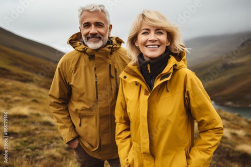 Elderly couple in nature, enjoying active retirement, smiling and embracing love