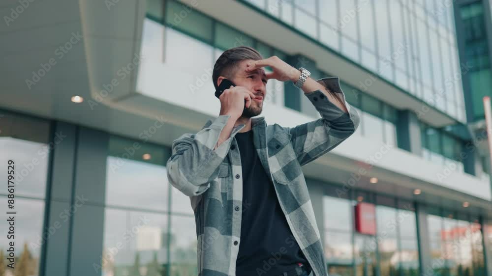 Male with Beard Having an Anxious Phone Conversation Outdoors Male with Beard Having an Anxious Phone Conversation Outdoors