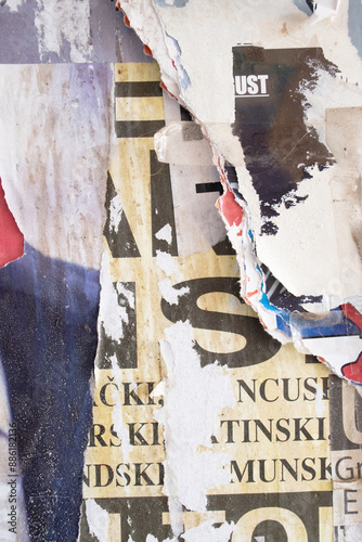 Ripped and torn old street poster background, messy and grungy paper collage backdrop photo