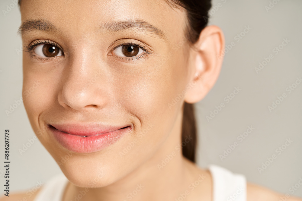 Teenage girl in vibrant attire exudes happiness with a warm smile on her face. Poses confidently, radiating positivity. Teenage girl in vibrant attire exudes happiness with a warm smile on her face. Poses confidently, radiating positivity.