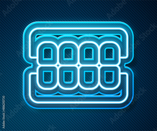Glowing neon line False jaw icon isolated on blue background. Dental jaw or dentures, false teeth with incisors. Vector