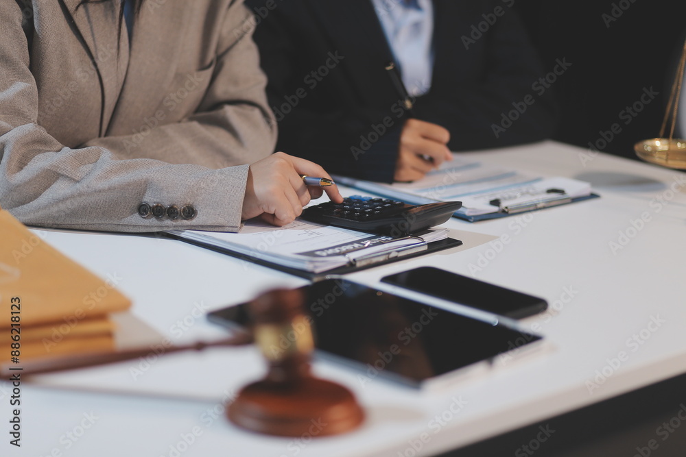 Judge gavel with Justice lawyers having team meeting at law firm background. Concepts of Law and Legal services. Judge gavel with Justice lawyers having team meeting at law firm background. Concepts of Law and Legal services.
