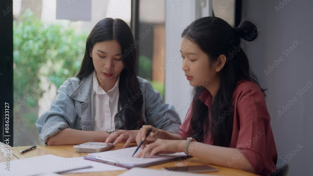 Two Asian college students meeting brainstorming in research university project Two Asian college students meeting brainstorming in research university project