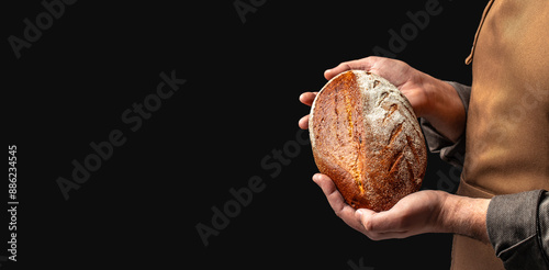 male baker holds homemade freshly baked rye gluten free bread, Long banner format. copy space for text