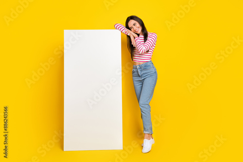 Photo of pretty lady interested look booking delievery service present big device panel empty space isolated on yellow color background photo