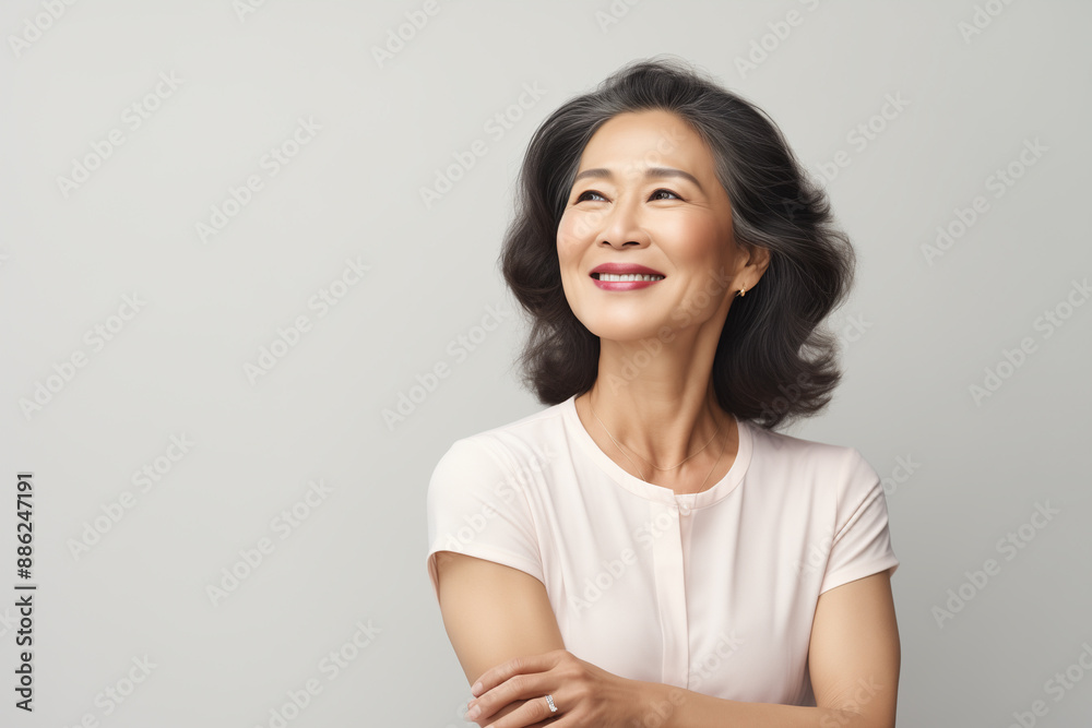 mature asian woman armscrossed on white background looking away smile mature asian woman armscrossed on white background looking away smile