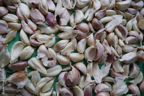 A close-up view showcasing garlic bulbs alongside pistachios, emphasizing natural ingredients and textures