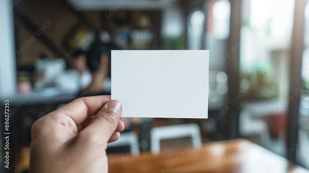 A person is holding a white card with a blank space on it A person is holding a white card with a blank space on it