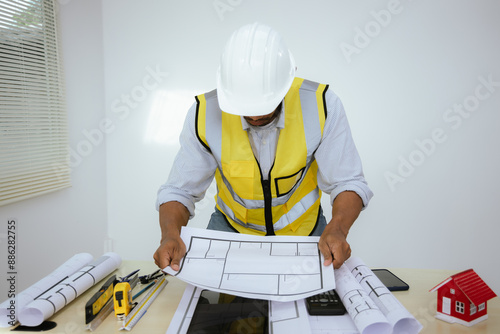 An architect is a professional who designs buildings and oversees their construction. They create blueprints, consult with clients, collaborate with engineers, and ensure projects meet industry standa photo