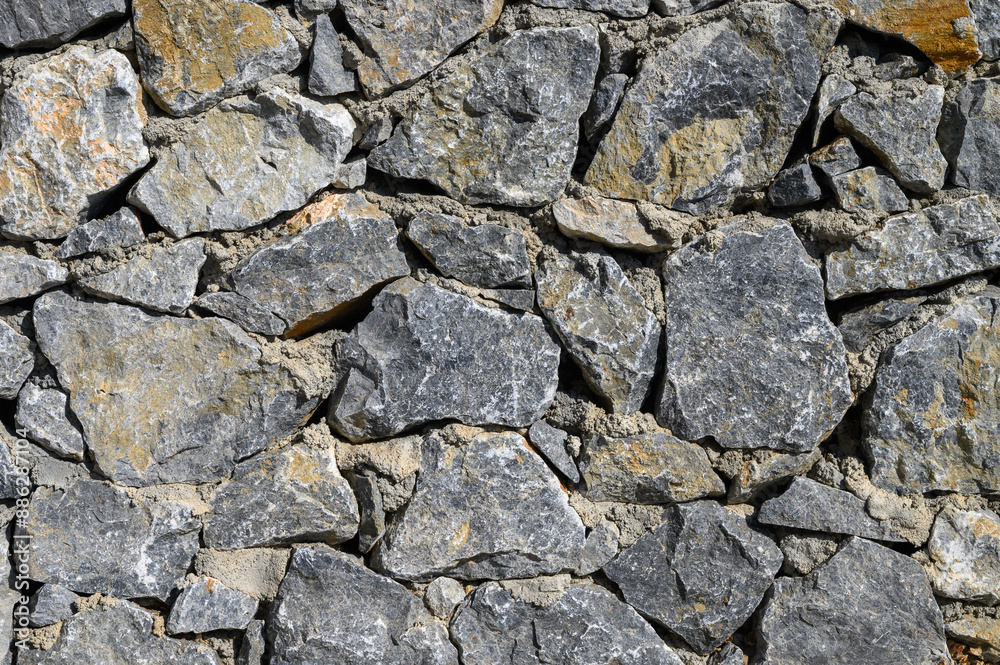 Old weathered stone wall of medieval fortress brick horizontal grunge background Old weathered stone wall of medieval fortress brick horizontal grunge background