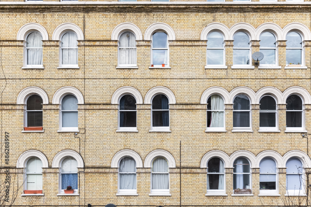 Facade of Georgian style apartment with arched windows in London Facade of Georgian style apartment with arched windows in London