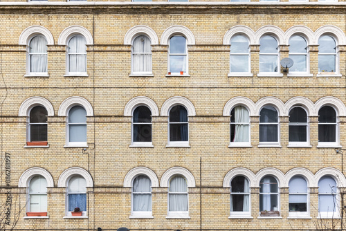 Facade of Georgian style apartment with arched windows in London