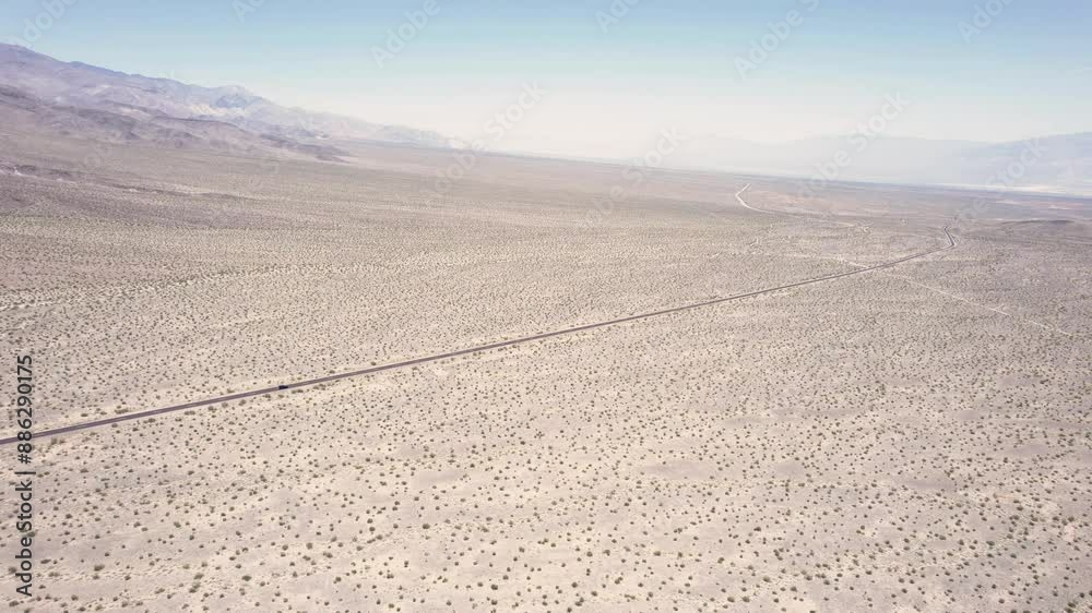 Drone following a car from far away driving in a desert landscape in 4k Drone following a car from far away driving in a desert landscape in 4k