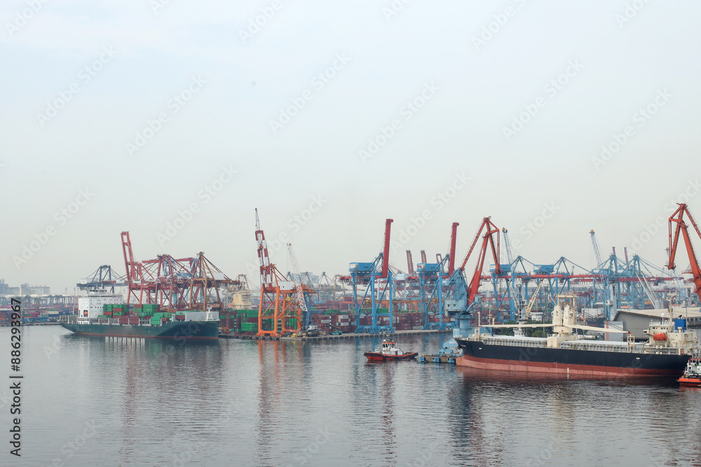 View Of Harbor Cranes And Container Ships In The Dock Of The Port View Of Harbor Cranes And Container Ships In The Dock Of The Port
