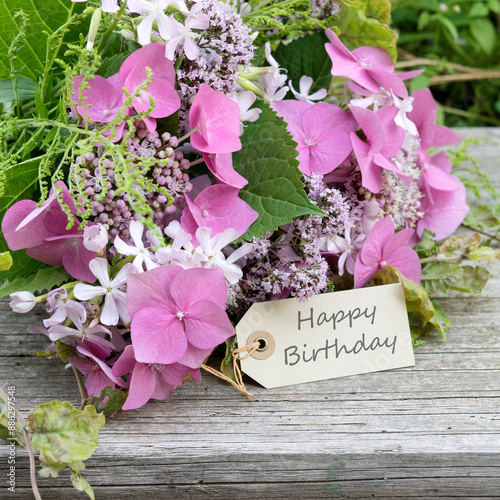 Greeting card with pink hydrangeas, soapwort, oregano and text: Happy Birthday
