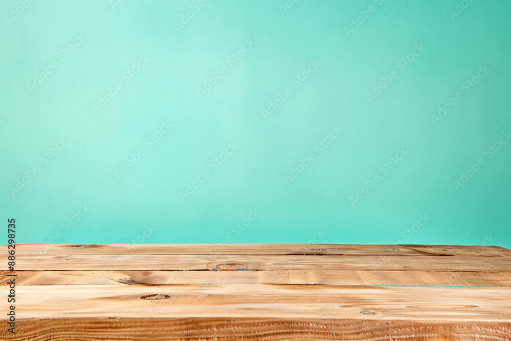 Empty light brown wood table top on pastel green background for product display montage, space photography Empty light brown wood table top on pastel green background for product display montage, space photography
