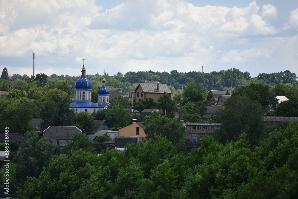 church. view of the Ukrainian church in the village. religion, Christianity. church holidays. crosses on the domes. no people. roofs of houses. summer or spring time. Orthodox temple. church. view of the Ukrainian church in the village. religion, Christianity. church holidays. crosses on the domes. no people. roofs of houses. summer or spring time. Orthodox temple.