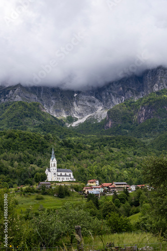 San Fermin Church immersed in the green of the Slovenian mountains a few steps from Caporetto. It remains a precious gem of Christianity and faith to be admired, makes the view of the mountain unique. photo