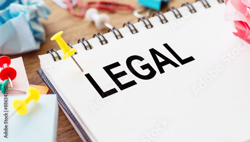 Legal Word Written On Notebook With Pins On Wooden Table