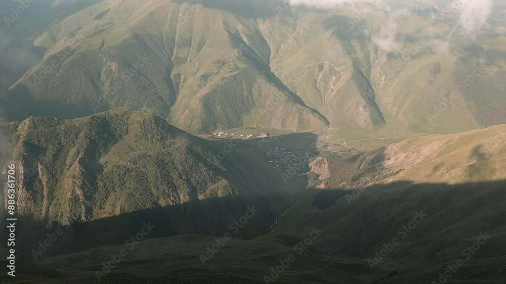 Aerial cinematic panning view woman loner alone stand camping enjoy sunshine by tent.Freedom in nature outdoors while camping in misty caucasus mountains Hidden gem - Angels mountain outdoors