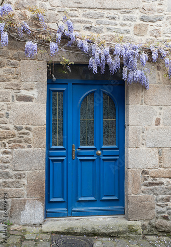 blue doors and old house with wisteria flowers in franch photo