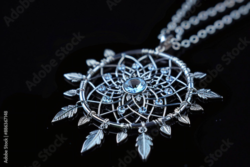 a silver necklace with a blue gem