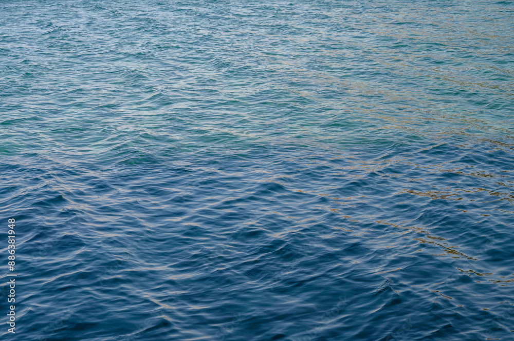 Top view of blue frothy sea surface. Shot in the open sea from above. Top view of blue frothy sea surface. Shot in the open sea from above.