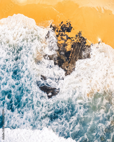 Wallpaper like looking drone photo of a beach with waves and sand photo