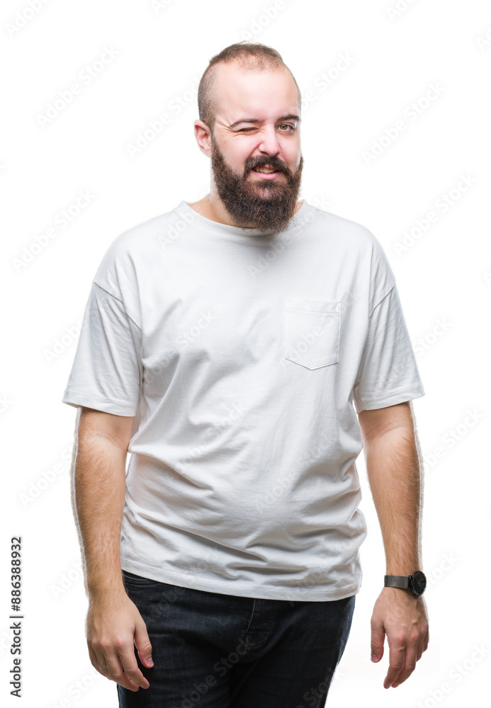 Fototapeta premium Young caucasian hipster man wearing casual t-shirt over isolated background winking looking at the camera with sexy expression, cheerful and happy face.