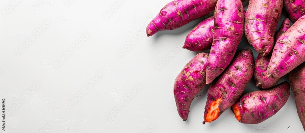 White background with a sweet potato; copy space image. White background with a sweet potato; copy space image.