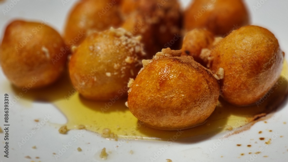 loukoumades with honey in the plate loukoumades with honey in the plate