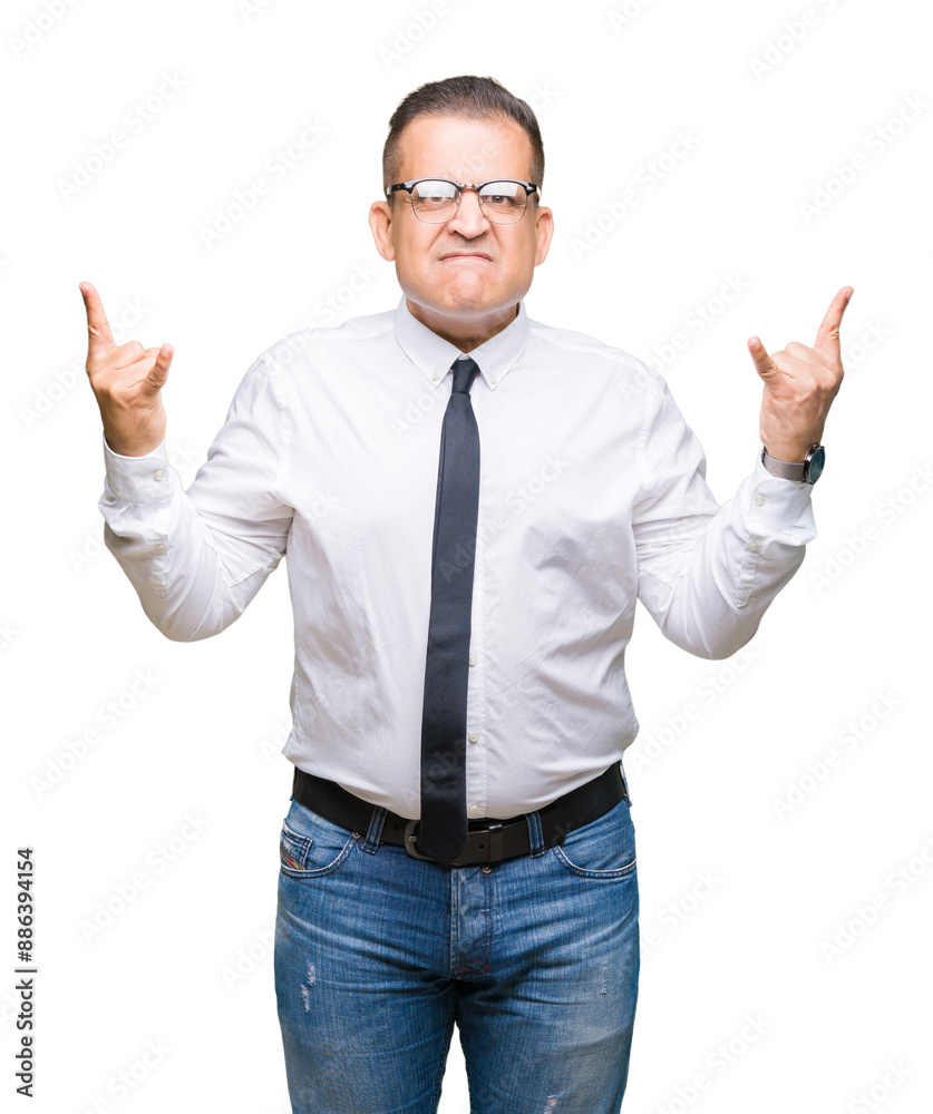 Middle age bussines arab man wearing glasses over isolated background shouting with crazy expression doing rock symbol with hands up. Music star. Heavy concept. Middle age bussines arab man wearing glasses over isolated background shouting with crazy expression doing rock symbol with hands up. Music star. Heavy concept.