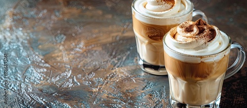 Two stylish glass cups showcasing frothy Dalgona coffee made through whipping instant coffee with water and sugar, with copy space image. photo