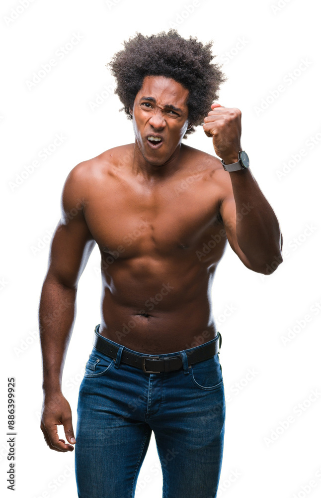 Fototapeta premium Afro american shirtless man showing nude body over isolated background angry and mad raising fist frustrated and furious while shouting with anger. Rage and aggressive concept.