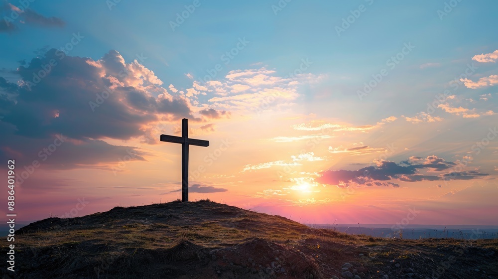 A solitary cross standing on a hill at sunset, with ample copy space, symbolizing Christian belief. A solitary cross standing on a hill at sunset, with ample copy space, symbolizing Christian belief.