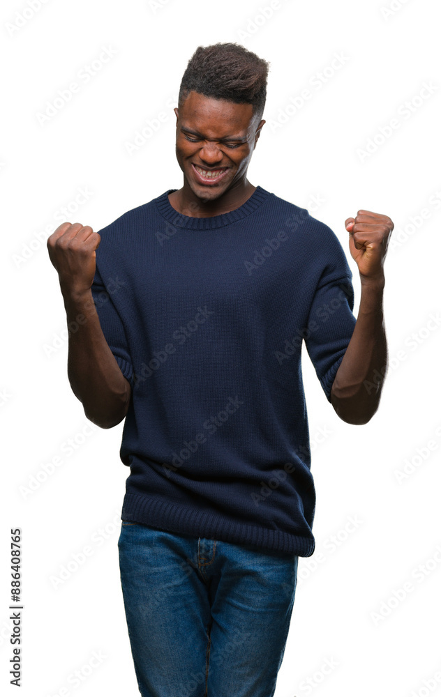 Young african american man over isolated background very happy and excited doing winner gesture with arms raised, smiling and screaming for success. Celebration concept. Young african american man over isolated background very happy and excited doing winner gesture with arms raised, smiling and screaming for success. Celebration concept.
