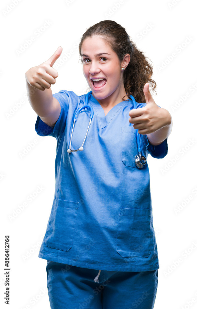 Young brunette doctor girl wearing nurse or surgeon uniform over isolated background approving doing positive gesture with hand, thumbs up smiling and happy for success. Looking at the camera. Young brunette doctor girl wearing nurse or surgeon uniform over isolated background approving doing positive gesture with hand, thumbs up smiling and happy for success. Looking at the camera.