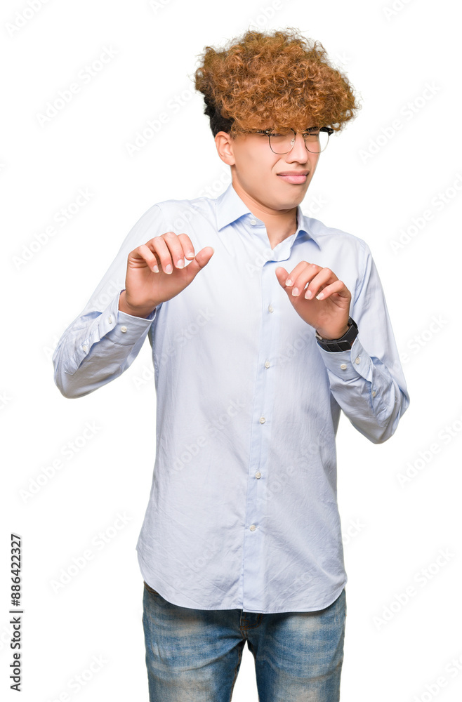 Young handsome business man with afro wearing glasses disgusted expression, displeased and fearful doing disgust face because aversion reaction. With hands raised. Annoying concept. Young handsome business man with afro wearing glasses disgusted expression, displeased and fearful doing disgust face because aversion reaction. With hands raised. Annoying concept.
