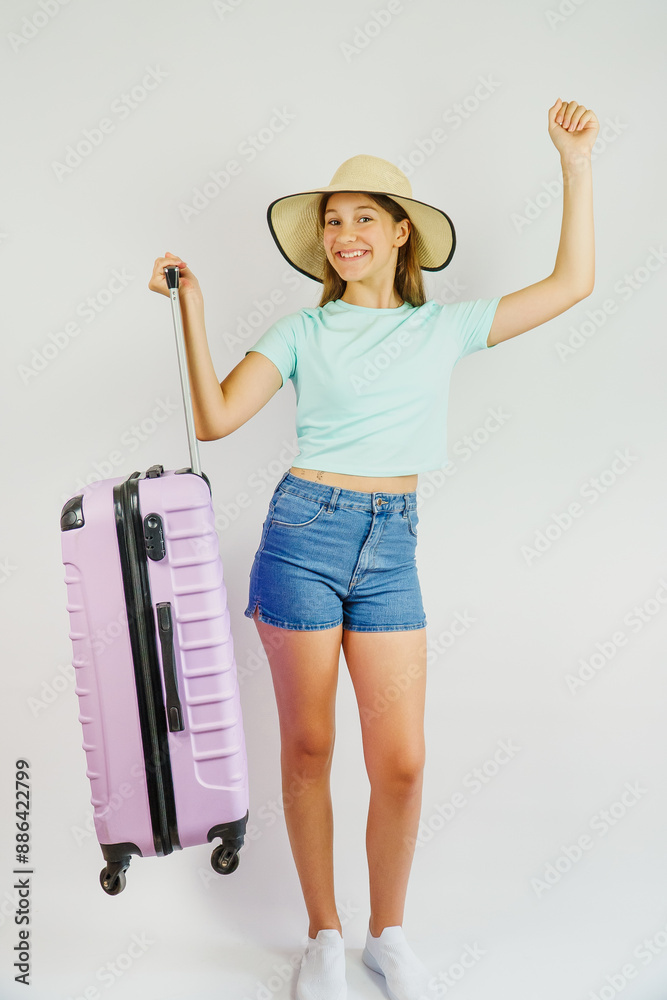 Cute child in a straw hat is happy to go on summer vacation. Travel and vacation, children's concept Cute child in a straw hat is happy to go on summer vacation. Travel and vacation, children's concept