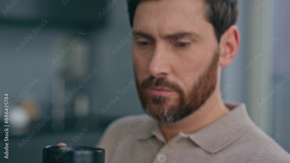 Relaxed businessman looking smartphone reading message in morning flat closeup