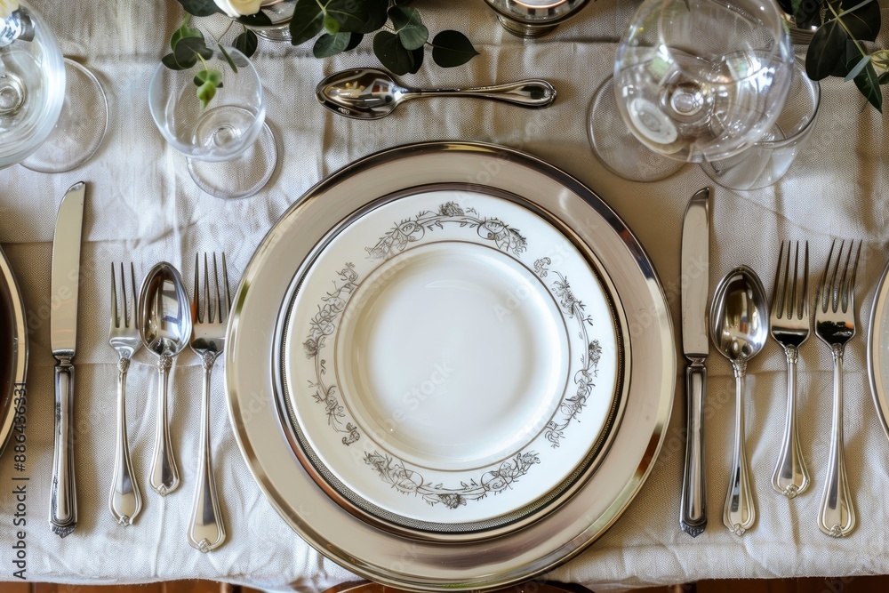 A table set with elegant silverware and dinnerware for a formal dining experience, Elegant dinnerware and silverware for a formal meal A table set with elegant silverware and dinnerware for a formal dining experience, Elegant dinnerware and silverware for a formal meal